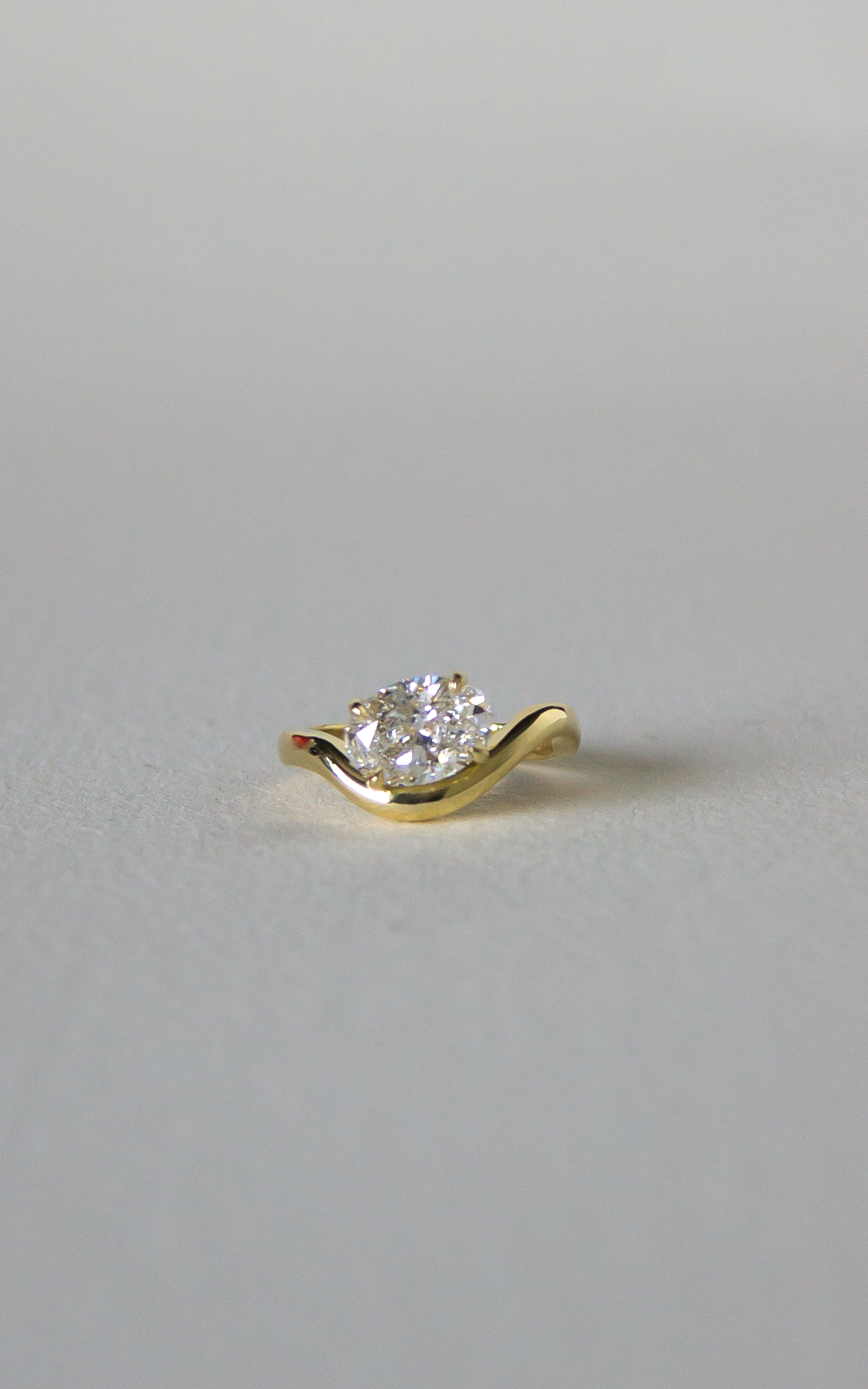 Atrium Oval Diamond Ring in yellow gold featuring a brilliant oval-cut diamond set in a sculptural band